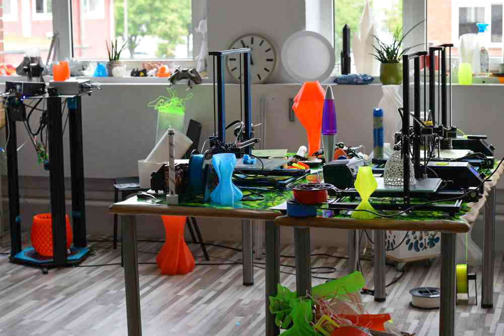 A small 3D printer farm with five devices.