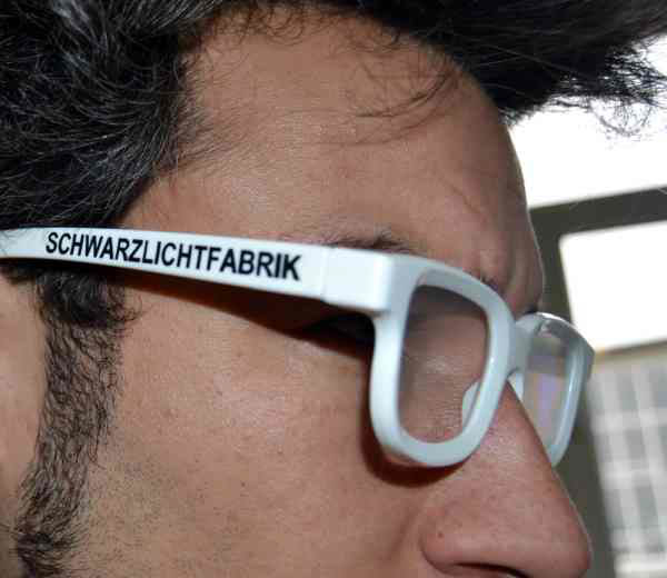 My side profile with a pair of 3D glasses, branded Schwarzlichtfabrik.